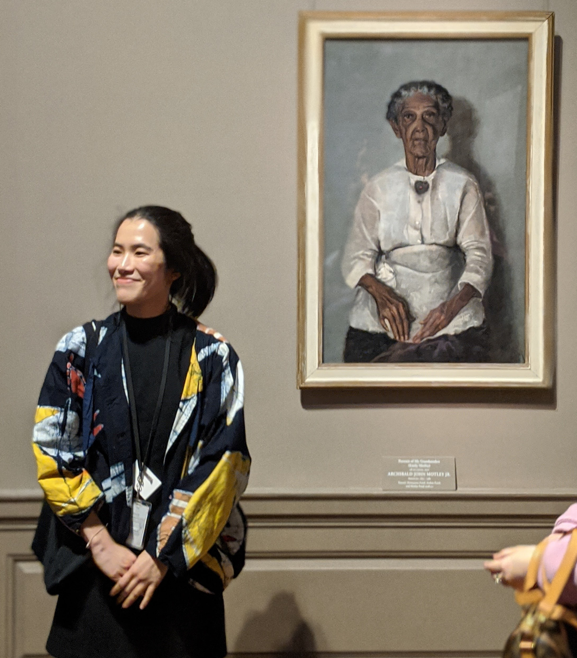 Annie leading a tour at the National Gallery of Art. She is standing in front of a portrait of Emily Motley, painted by John Motley.